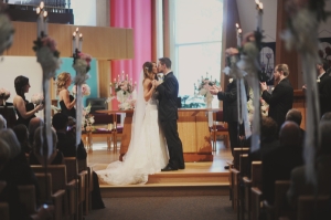 Bride-and-Groom-Kissing-at-Church-Ceremony-600x399